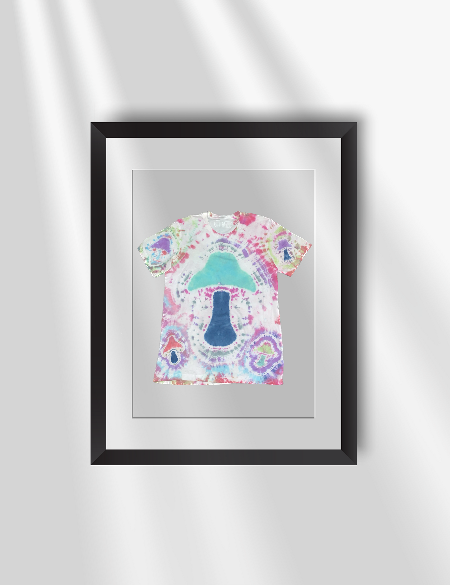 Schleepwear Tye Dye Zephyrazure Tshirt inside a picture frame.