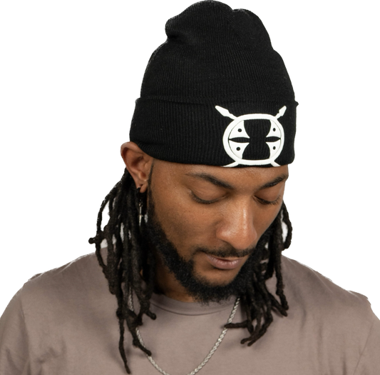 male model looking down wearing a black Schleepwear logo beanie.